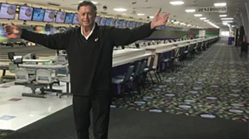Jim Mellon posing with arms wide at Midway Lanes