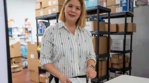 Hispanic woman owned business owner inside their warehouse