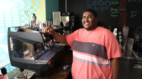 Coffee shop owner and barista celebrates local coffee and tea