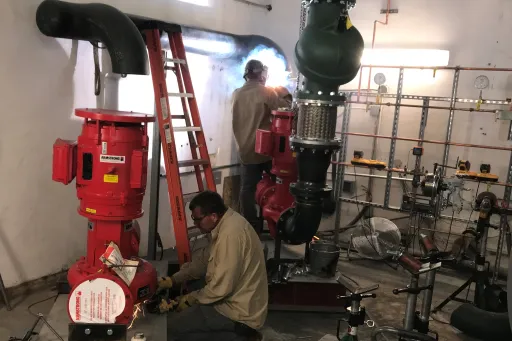 Workers put together water pump installation